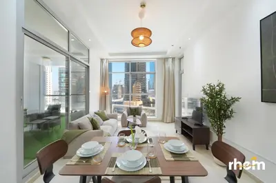 a living room with a table and a couch at Brand New 2-BR Apartment in Dubai Marina - JBR in Dubai