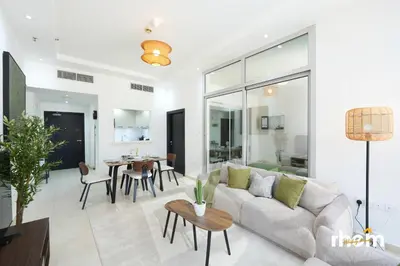 a living room with a couch and a table at Brand New 2-BR Apartment in Dubai Marina - JBR in Dubai