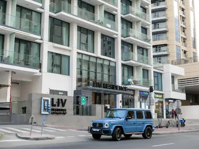 a blue jeep parked in front of a building at Full Dubai Marina View 2BR Apartment in Dubai