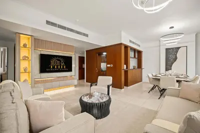 a living room with a couch and a table at Stunning 2BR with Burj Lake View at The Residences in Dubai