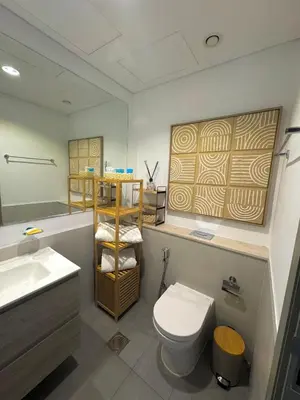 a bathroom with a white toilet and a sink at Modern Flat close to Burj Khalifa with stunning pool in Dubai