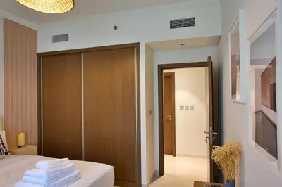 a bedroom with a bed with a sliding door at Luxury 2BR Private Beach Partial Sea View in Dubai