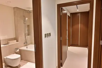 a bathroom with a toilet and a bath tub at Luxury 2BR Private Beach Partial Sea View in Dubai
