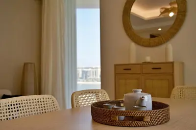 a table with a tea kettle on top of it at Luxury 2BR Private Beach Partial Sea View in Dubai