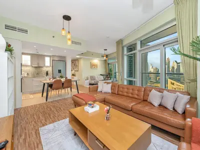 a living room with a couch and a table at 2BR Panoramic City - Burj and Fountain View in Dubai