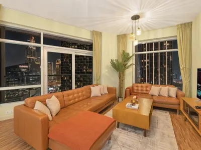 a living room with a couch and two couches and windows at 2BR Panoramic City - Burj and Fountain View in Dubai