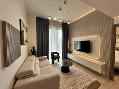 a living room with a couch and a tv at Chic 1bhk Smart Apartment, near circle Mall in Dubai