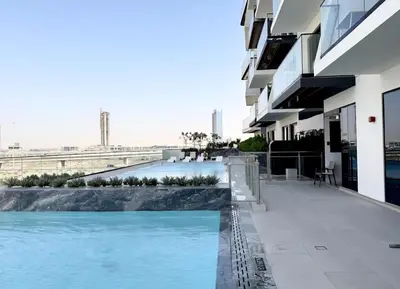 a swimming pool on the side of a building at Chic 1bhk Smart Apartment, near circle Mall in Dubai