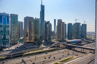 a city with a highway and many tall buildings at Modern Studio with Skyline Views in Dubai Marina in Dubai
