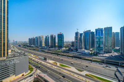 a highway in a large city with tall buildings at Modern Studio with Skyline Views in Dubai Marina in Dubai