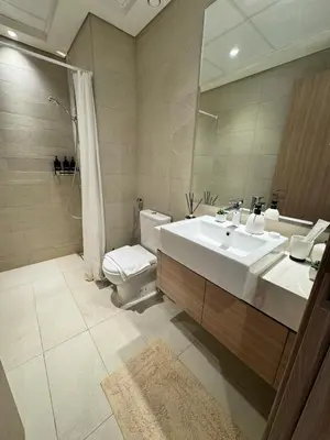 a bathroom with a sink and a toilet and a mirror at Beautiful Studio Brand New in Dubai