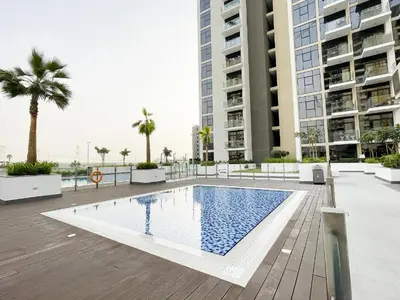 a swimming pool in front of some tall buildings at Beautiful Studio Brand New in Dubai