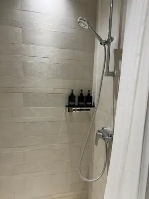 a shower with a shower head in a bathroom at Beautiful Studio Brand New in Dubai