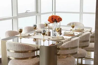 a dining room with a white table and chairs at Sky Palace 3 Bedroom Penthouse on JBR in Dubai