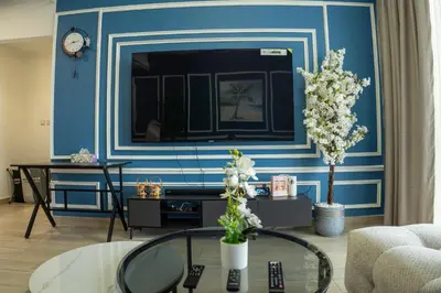 a living room with a blue and white wall at Bloom Tower B-Stunning View-Luxurious Furnish-Pool View in Dubai
