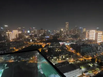 a view of a city at night with buildings at Bloom Tower B-Stunning View-Luxurious Furnish-Pool View in Dubai