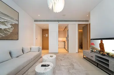 a living room with a couch and a tv at Luxury 1 Bed Address JBR Direct Beachfront Living in Dubai