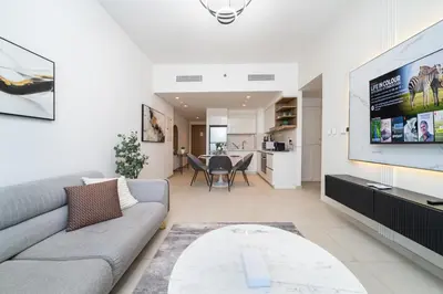 a living room with a couch and a tv at Stylish 1 Bed in Downtown with Dubai Mall Access in Dubai