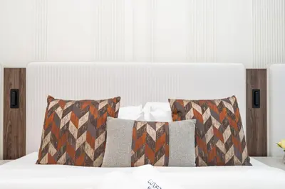 a white bed with two pillows on top of it at Stylish 1 Bed in Downtown with Dubai Mall Access in Dubai