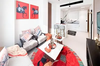 a living room with a couch and a table at Modern Place - Trillionaire Residence 608 in Dubai
