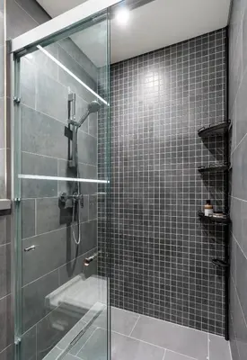 a bathroom with a glass shower with a sink at Stylish Flat in Dubai in Dubai