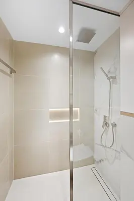 a shower with a glass door in a bathroom at Aura by Grovy 405 - Parking, Pool&Gym - by Rentujemy in Dubai