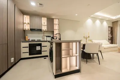 a kitchen with a counter and a dining room at Venetian - Elegant 1BR in JVC & Perfect for Work Leisure in Dubai