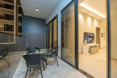 a dining room with a glass table and chairs at Venetian - Elegant 1BR in JVC & Perfect for Work Leisure in Dubai