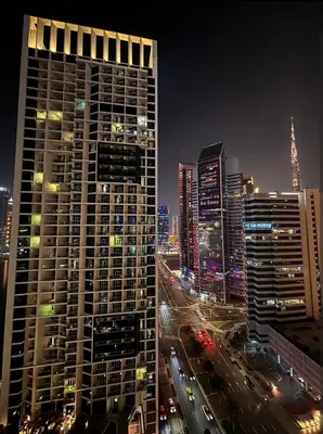 a view of a city at night with buildings at Luxury Apartment with canal view - near to Burj Khalifa - Dubai in Dubai