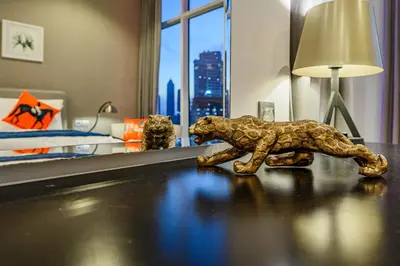 a figurine of a bear on a table in a bedroom at Luxury Apartment with canal view - near to Burj Khalifa - Dubai in Dubai