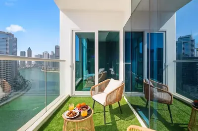 a balcony with a table with food on it at Luxury Apartment with canal view - near to Burj Khalifa - Dubai in Dubai