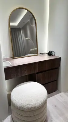 a bathroom with a mirror and a stool and a sink at Burj, Canal & Dubai Mall Luxe Stay for 6 in Dubai