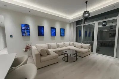 a living room with a couch and a table at Burj, Canal & Dubai Mall Luxe Stay for 6 in Dubai