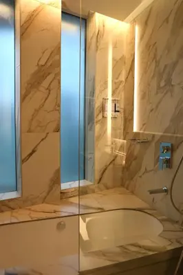 a bathroom with a shower and a tub and a sink at Marina View 2BHK Luxury in Dubai