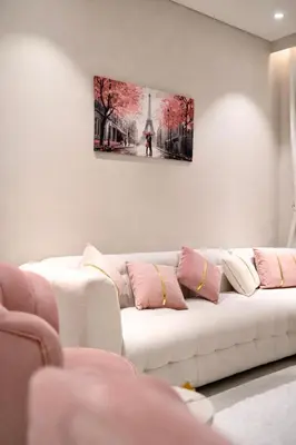 a white couch in a living room with a picture on the wall at Marina View 2BHK Luxury in Dubai