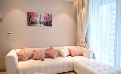 a living room with a white couch with pillows at Marina View 2BHK Luxury in Dubai