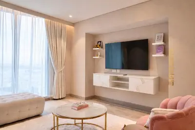 a living room with a television on a wall at Marina View 2BHK Luxury in Dubai