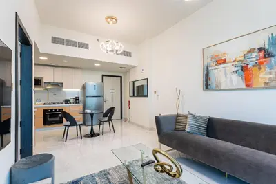 a living room with a couch and a table at HAVN - 1 Bedroom in Skyz, 5 mins to Miracle Garden in Dubai
