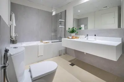 a white bathroom with a sink and a toilet at Frank Porter - Bahar 6 in Dubai