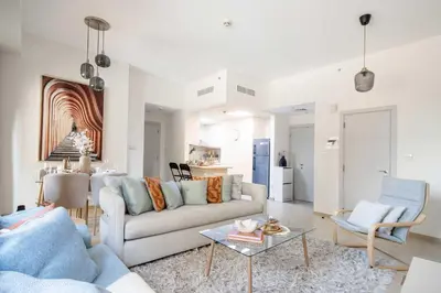 a living room with a couch and a table at Frank Porter - Bahar 6 in Dubai