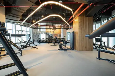 a gym with several rows of treadmills and machines at Waves - Chic Business Bay 1BR - Bright and Modern in Dubai
