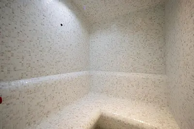 a corner of a bathroom with a white tiled wall at Waves - Chic Business Bay 1BR - Bright and Modern in Dubai