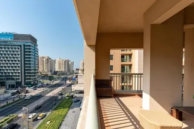 a balcony with a view of a city at Walnut Palm 2BR - Palm Jumeirah in Dubai