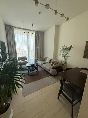 a living room with a couch and a table at Modern 1BR in JVC, Pool & Gym Near Circle Mall in Dubai