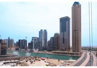 a city skyline with tall buildings and a freeway at KeyRock Living - Modern 1BR at Zada Tower with Pool and Gym Facilities in Dubai