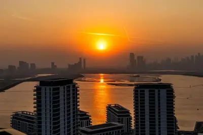 a sunset over a city with tall buildings at Extra Luxury High Floor Skyline View Stylish in Dubai