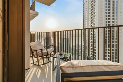 a balcony with a bed and a chair on a balcony at Extra Luxury High Floor Skyline View Stylish in Dubai