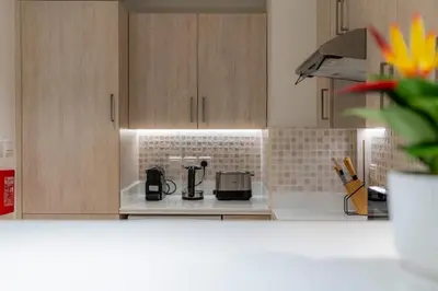 a kitchen with a coffee maker on a counter at Stylish 1-BR Beachfront Apt on SEVEN PALM Dubai in Dubai