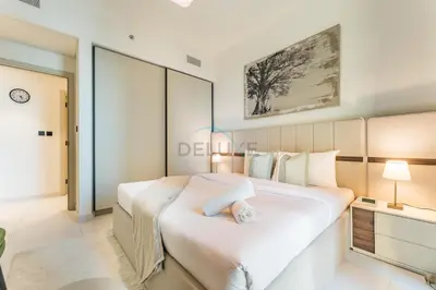 a bedroom with a large bed in a room at Steps Away From JBR Beach And Marina Promenade, Quick Access To Palm Jumeirah, Surrounded by Leisure And Entertainment Hubs - Marina Vista Tower 2, Emaar Beachfront by Deluxe Holiday Homes in Dubai