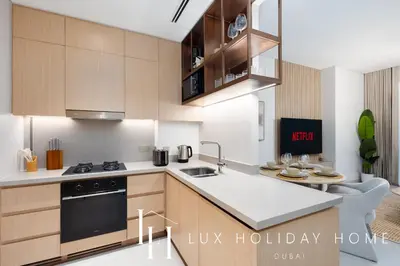 a kitchen with a sink and a stove top oven at LUX The Vida Burj Khalifa View Suite in Dubai